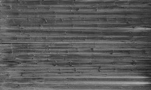Black and white wallpaper mural of an old barn wood wall. This wallpaper mural brings in depth and texture. These wood barn boards are a perfect accent to create that rustic feel in your space.